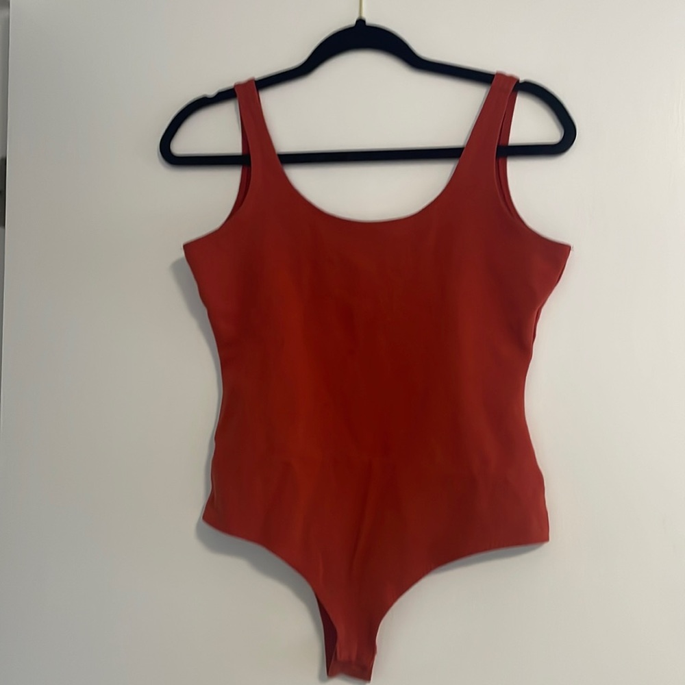 Brand unknown, size M, burnt orange bodysuit.